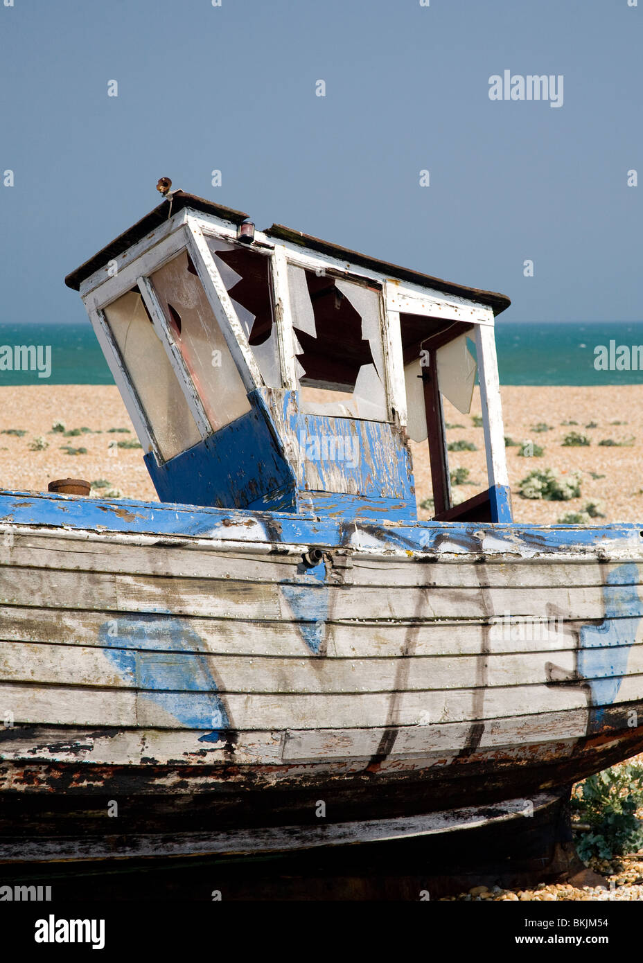 abandoned wrecked fishing boat and engines on the shingle beach in ...