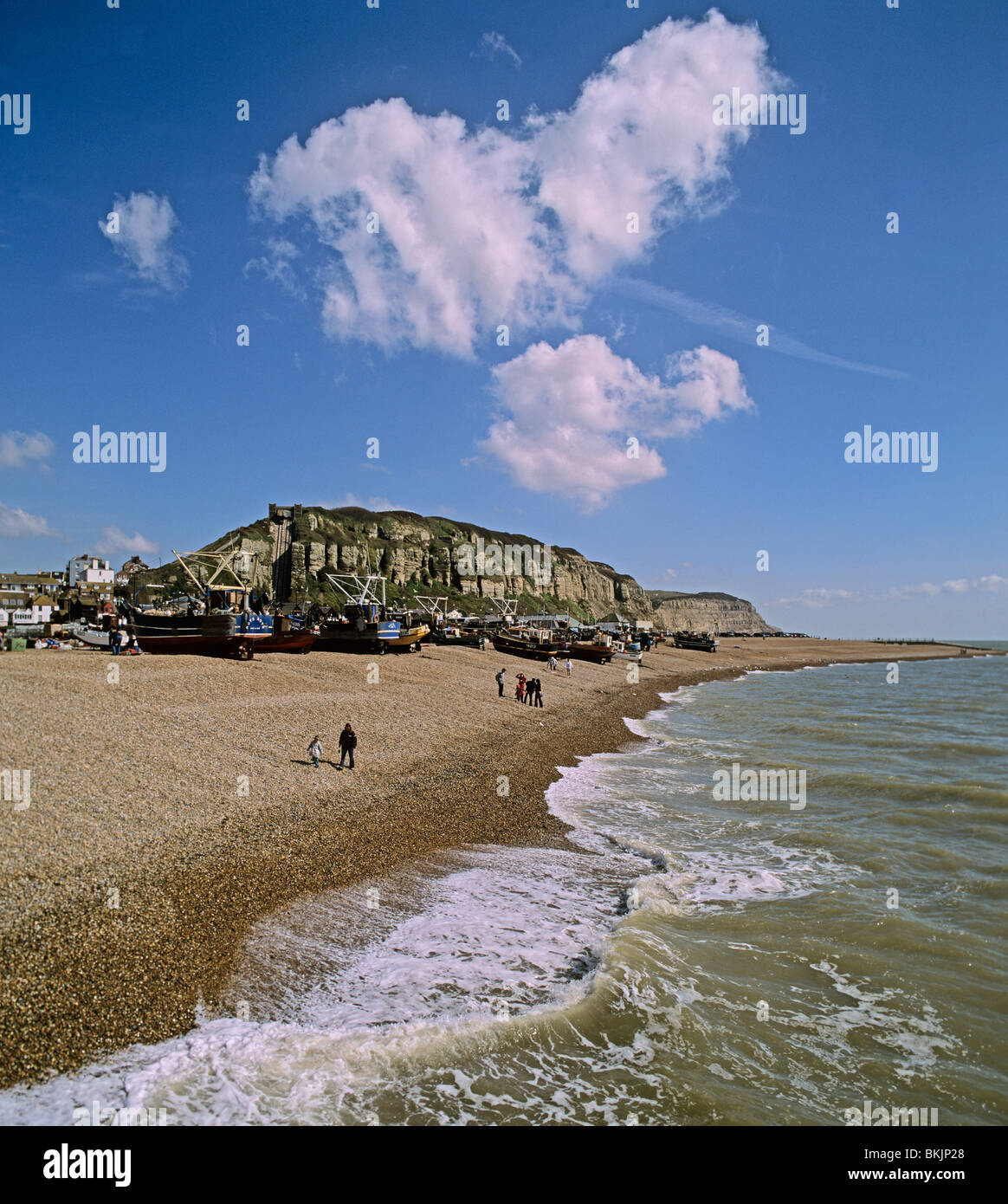 Shingle beach at Hastings East Sussex towards the Old Town the fishing fleet and East Hill Stock Photo