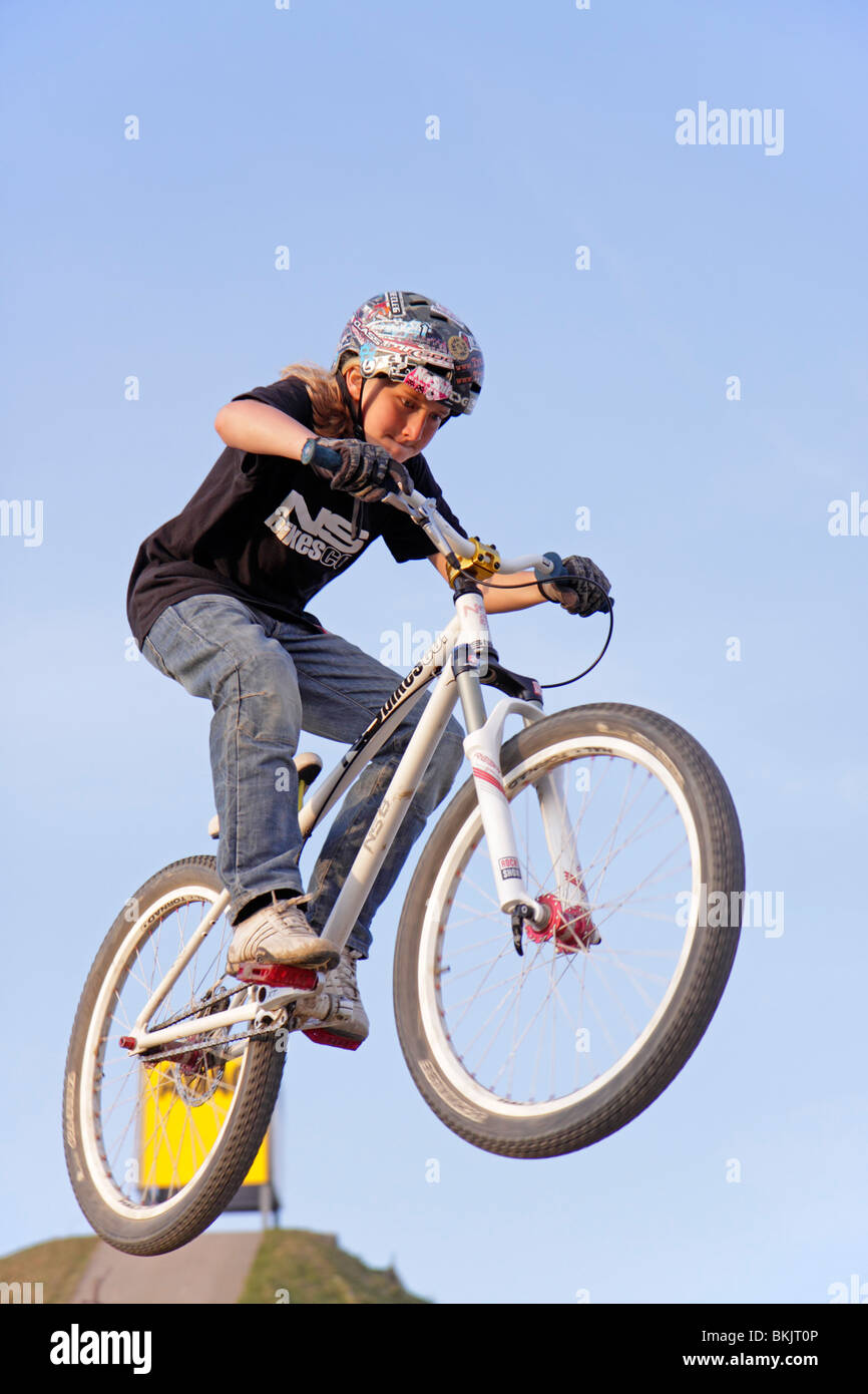 young boy jumping with his bike Stock Photo