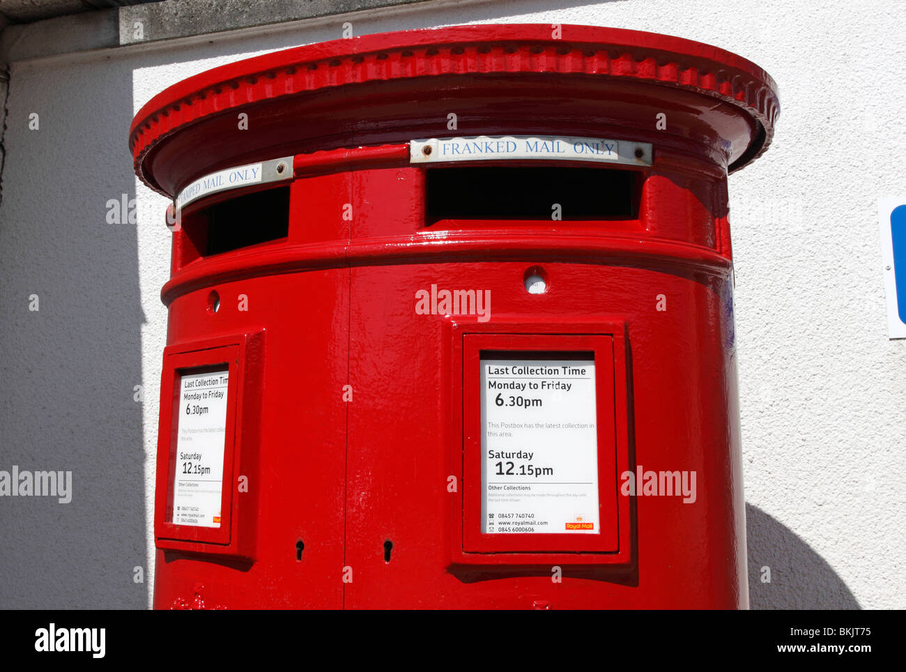 A red British two slot royal mail post box for stamped and franked mail in Redruth, Cornwall UK Stock Photo