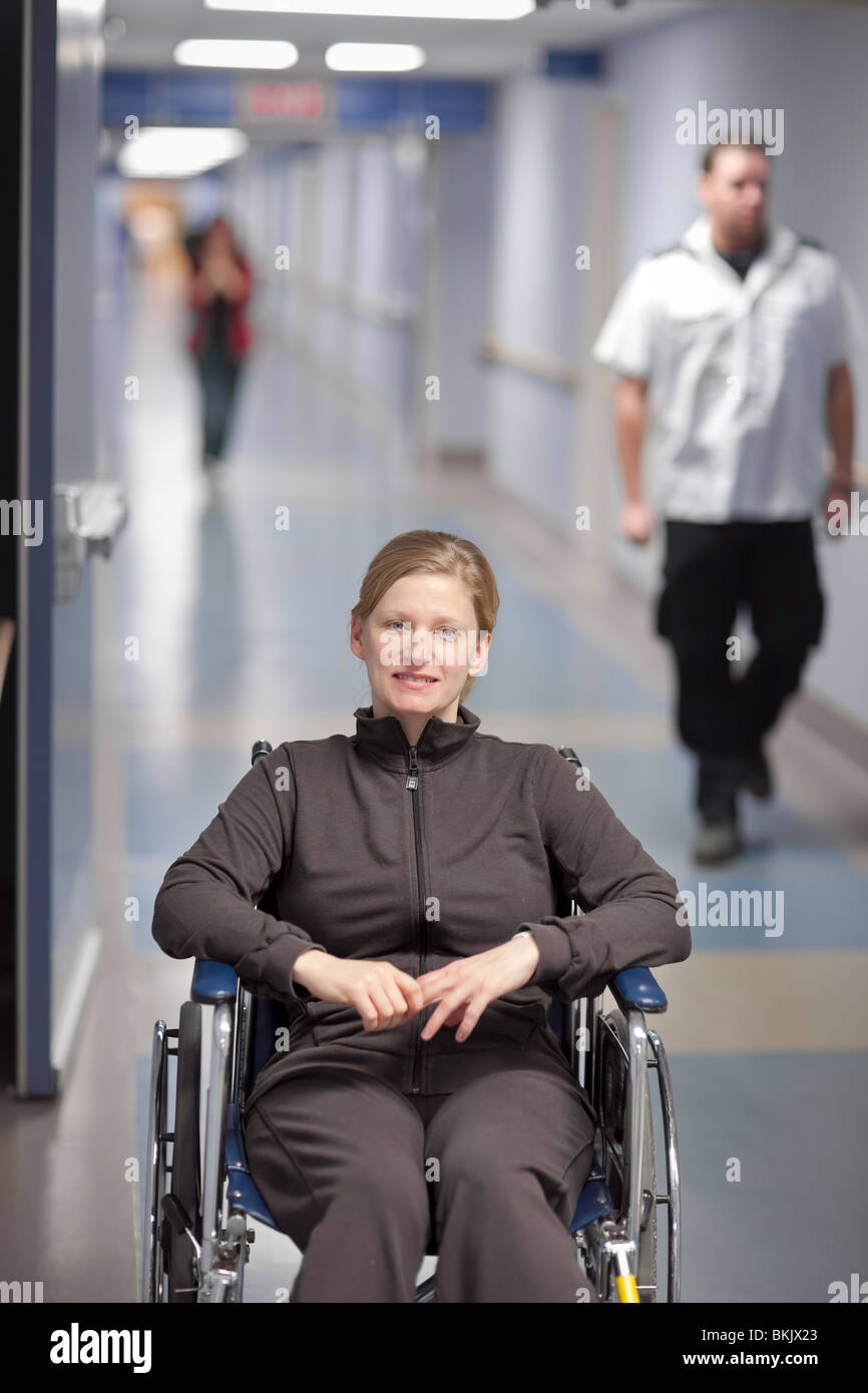 Woman in a wheelchair, in a hospital hallway. Stock Photo