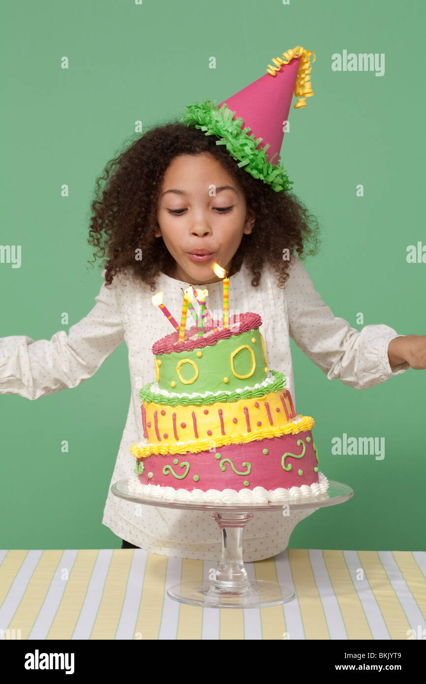Girl with Birthday cake, blowing out candles Stock Photo Alamy