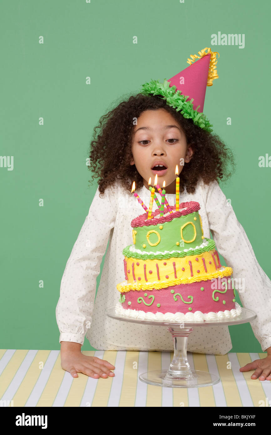 Girl with Birthday cake, blowing out candles Stock Photo Alamy