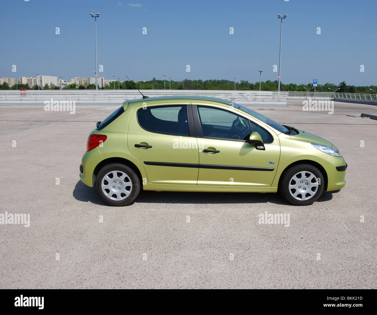 Peugeot 207 1.4 - 2009 (FL) - yellow metallic - three doors (3D) - French popular subcompact city car - on parking space Stock Photo