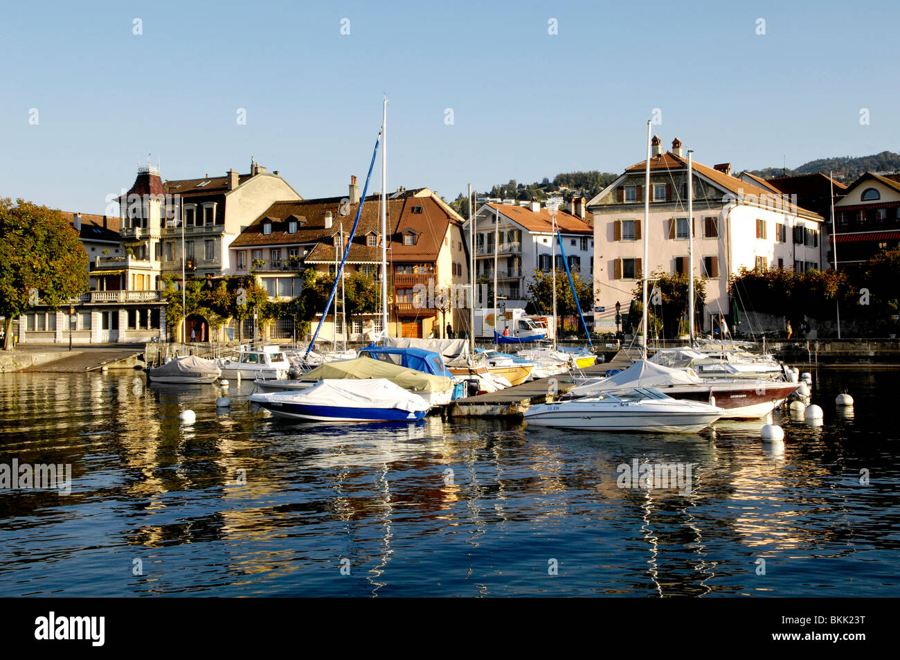 sailing and motor boats in lutry harbour, in the medieval Swiss town of