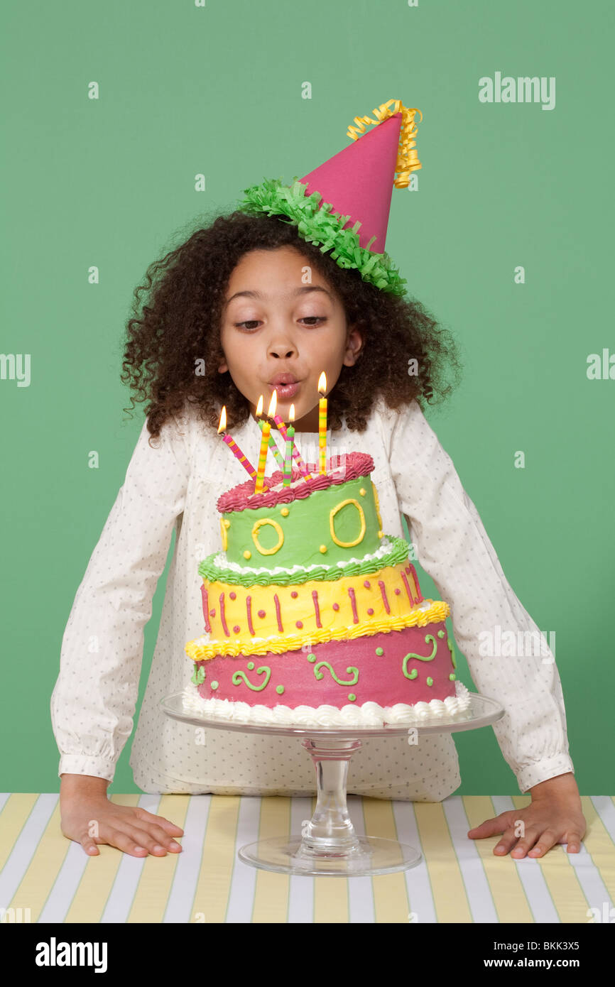 Girl with Birthday cake, blowing out candles Stock Photo Alamy