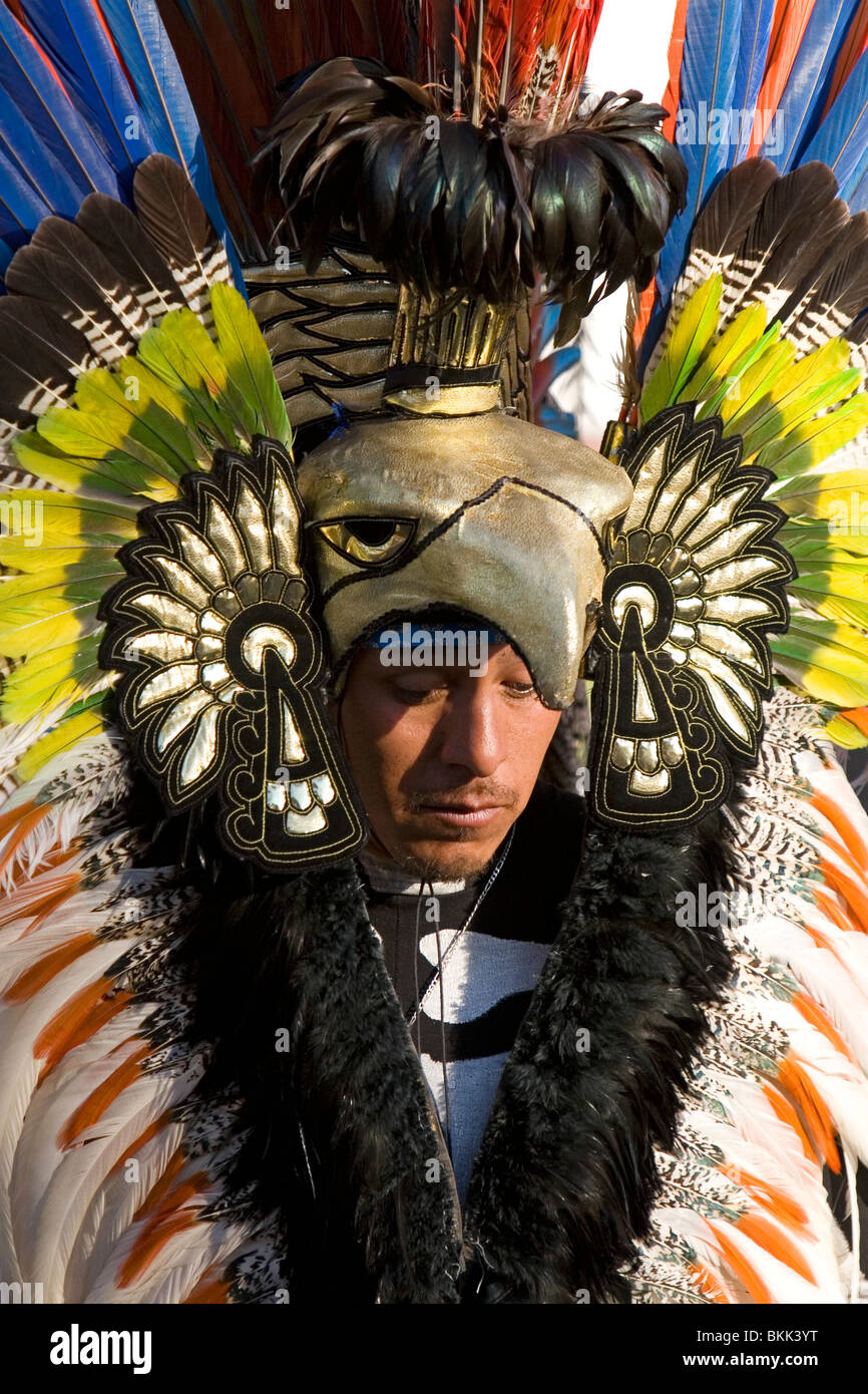Native Aztec people dance wearing tradional costume in the Zocalo of Mexico City, Mexico. Stock Photo