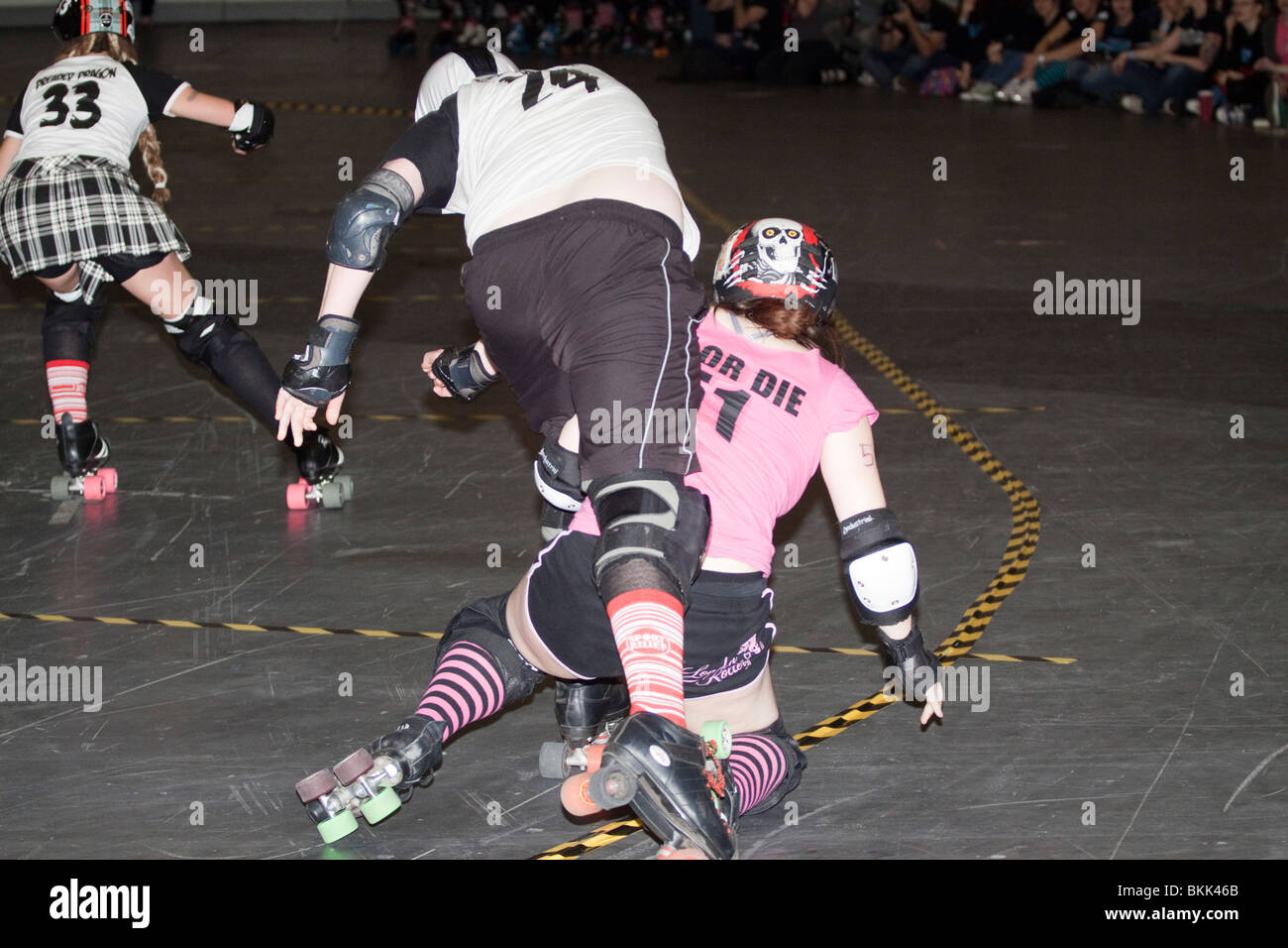 Glasgow Roller Girl falls over a London Roller Girl at a roller derby