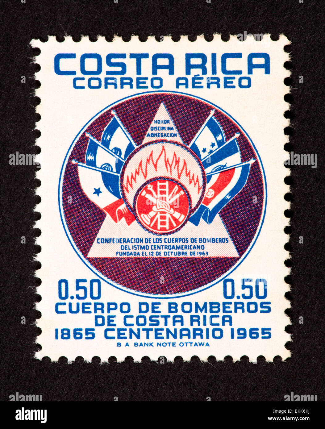 Postage stamp from Costa Rica depicting the emblem and flags of the Confederation of the Central American Fire Brigade Stock Photo