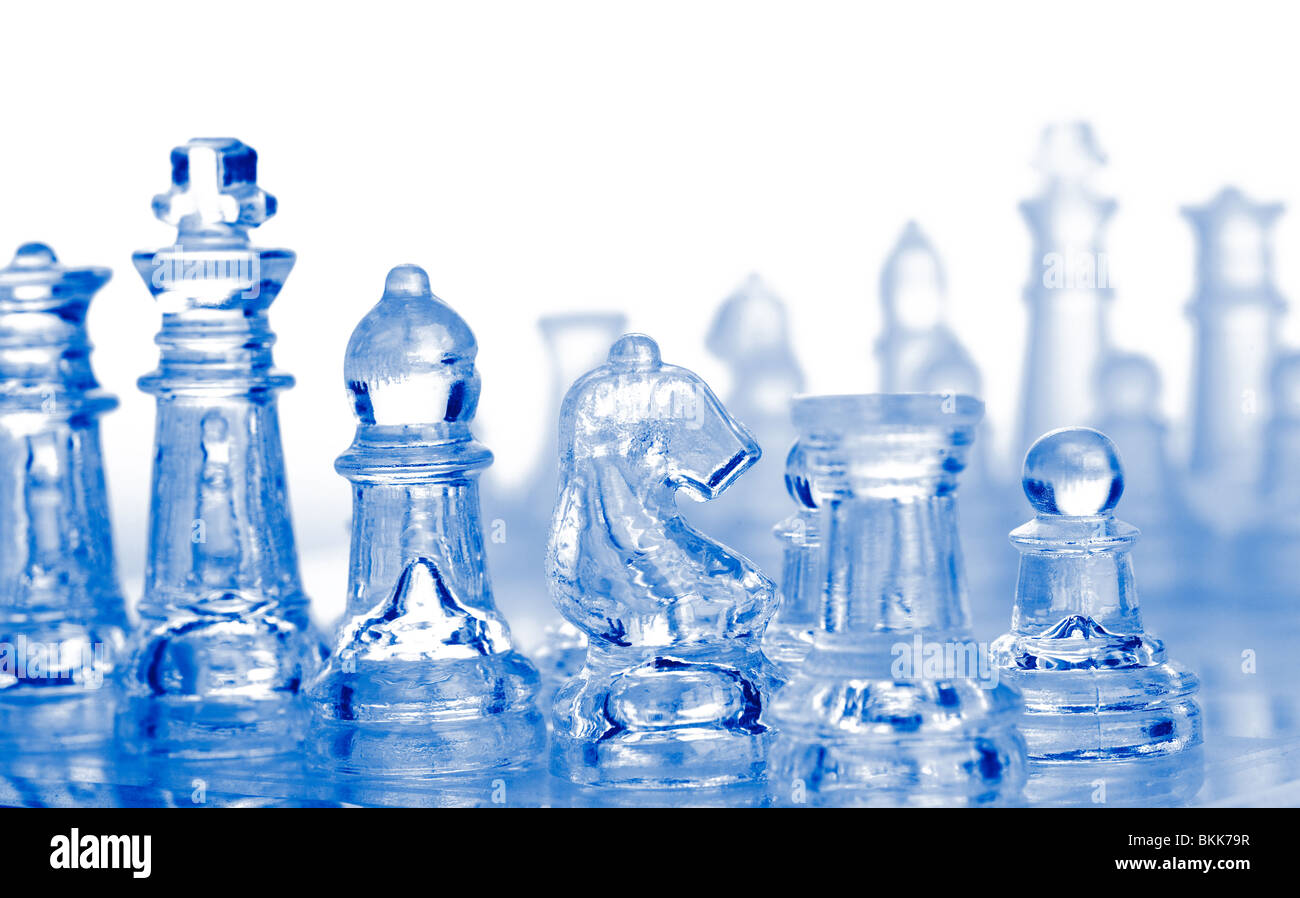 glass chess pieces with blue light Stock Photo