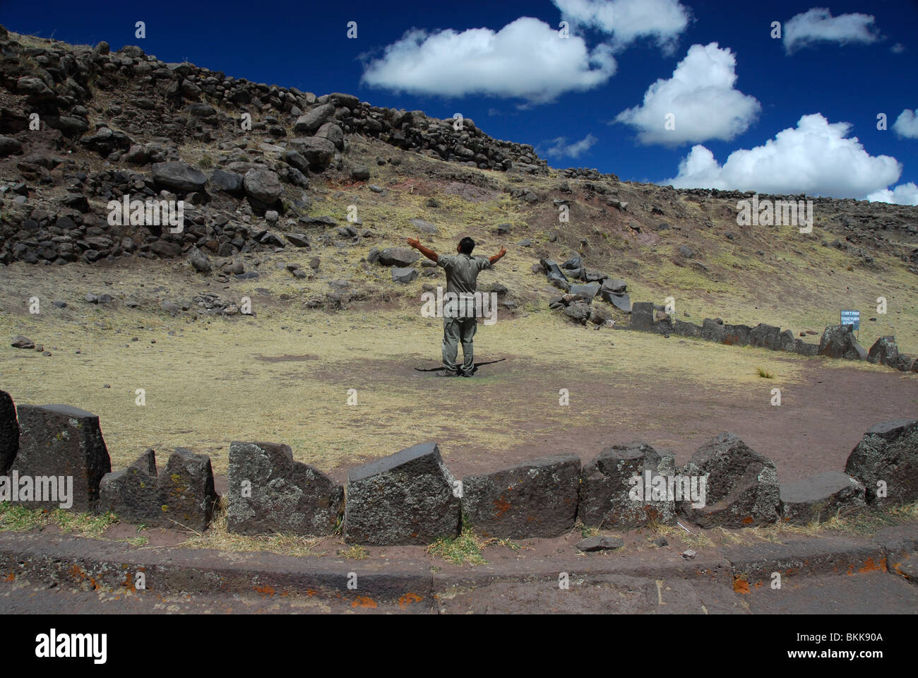 Local guide presenting a ceremony in Sillustani ruins, Lake Umayo, Peru, South America Stock Photo