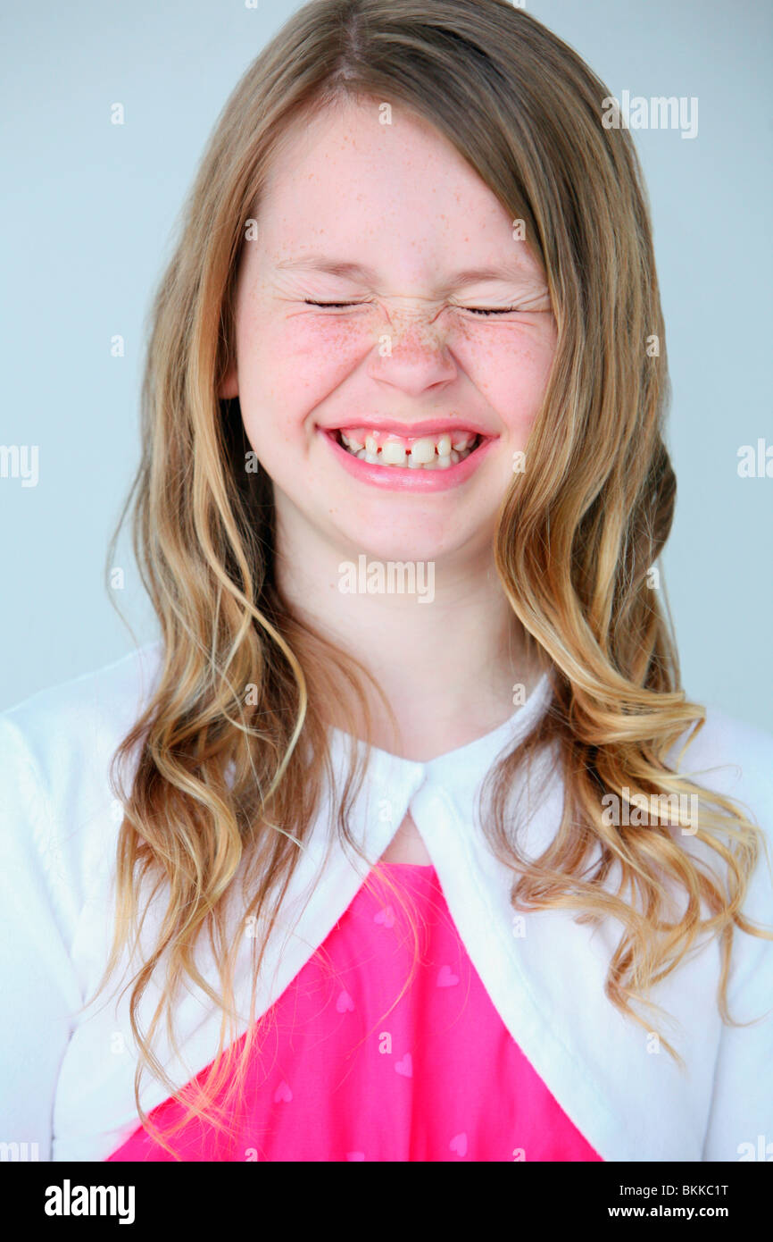 A Young Girl Squeezing Her Eyes Shut Stock Photo Alamy