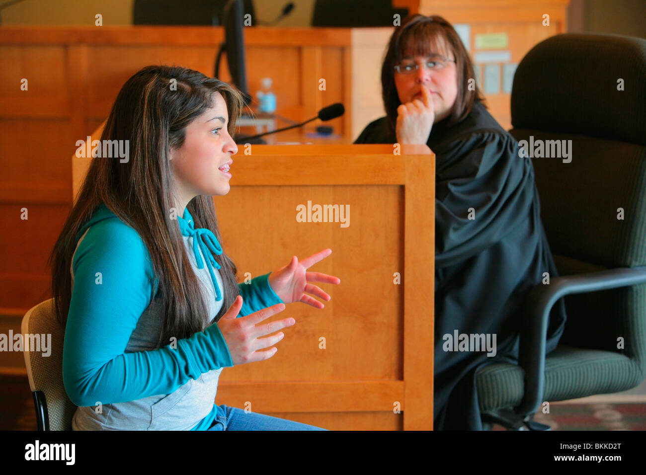 A Teenage Girl Giving Her Testimony Before A Judge Stock Photo