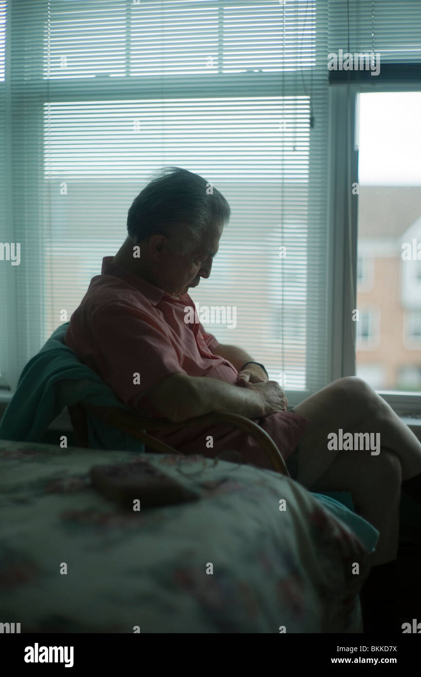 Old man sleeps sitting up in chair by bedroom window Stock Photo Alamy