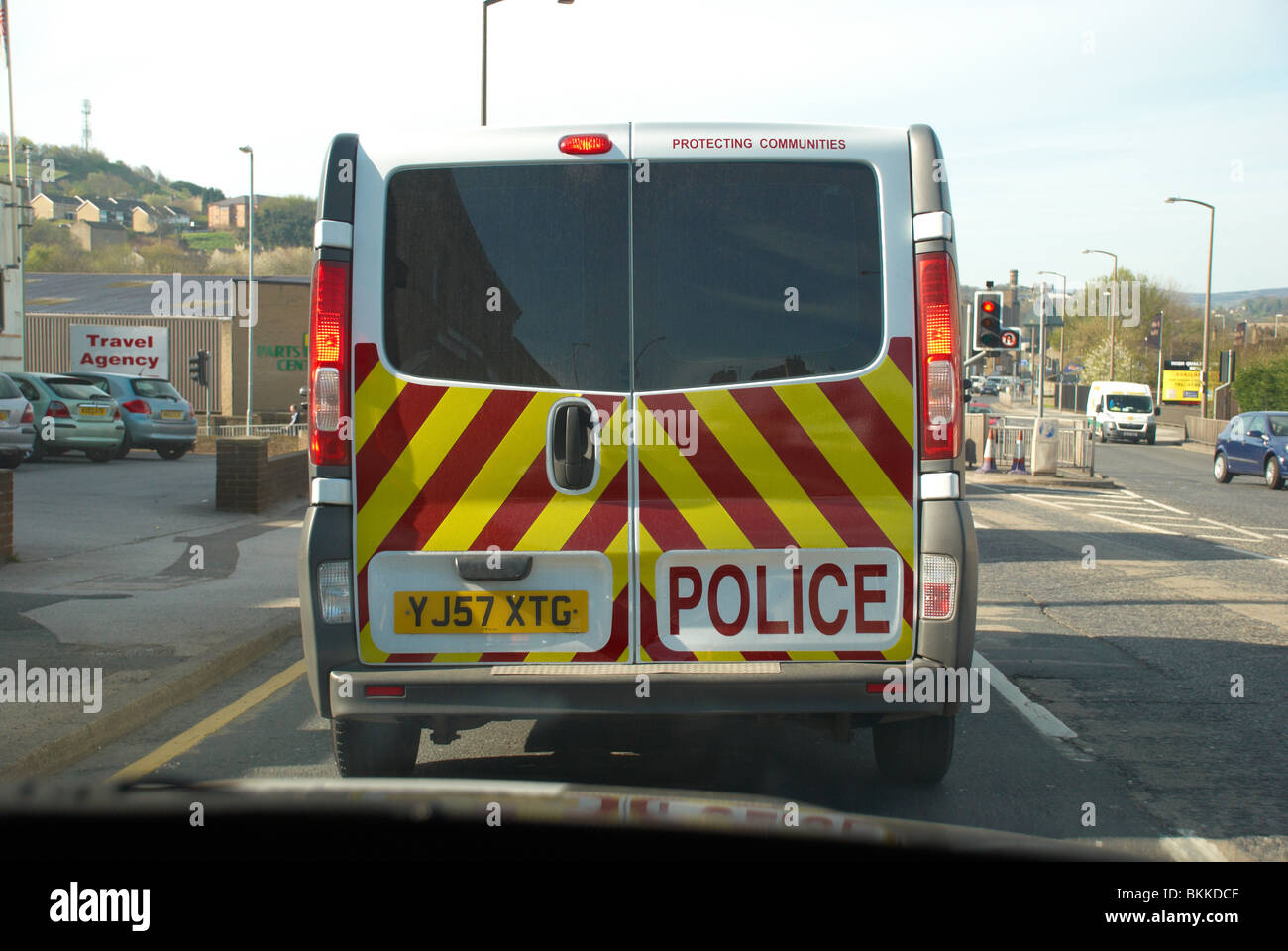 Police van at traffic lights (Chapel Hill, Huddersfield). Stock Photo
