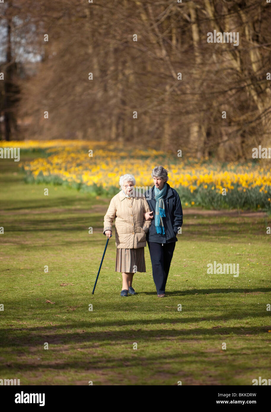 two women walking in a public park Stock Photo