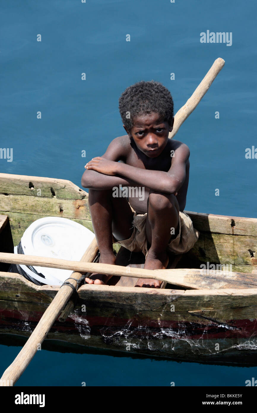 starving african street kid asking for food in wooden boats,Africa Stock Photo