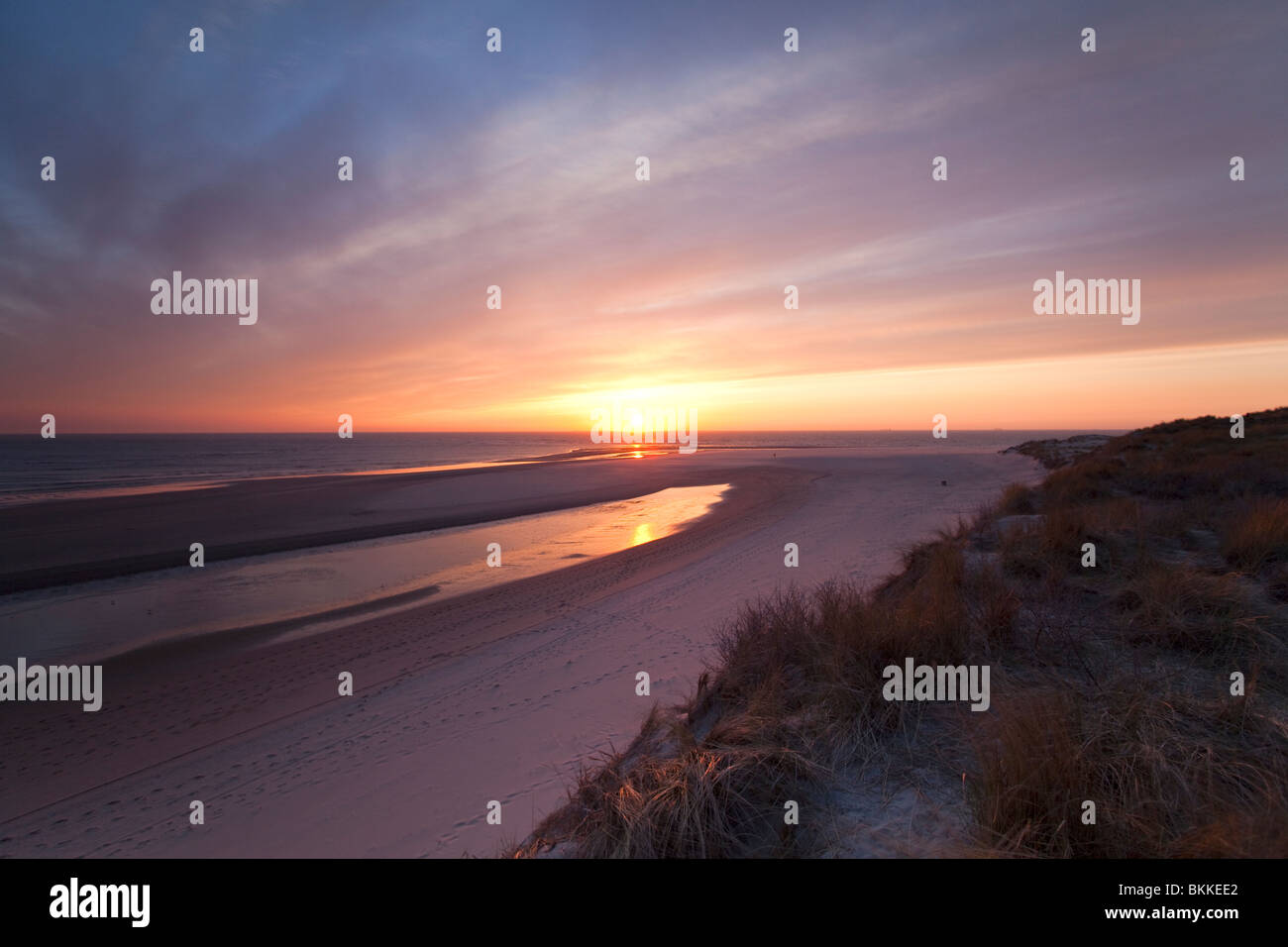 Colorful reflection sunset due to Icelandic volcanic ash at empty Dutch beach called Slufter near Rotterdam 15 April 2010 Stock Photo