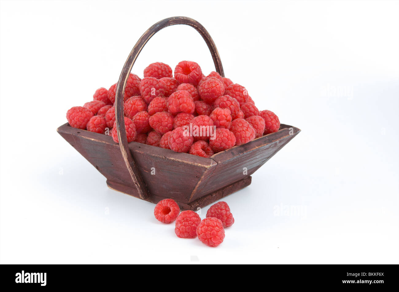 Raspberries in a wooden basket Stock Photo Alamy