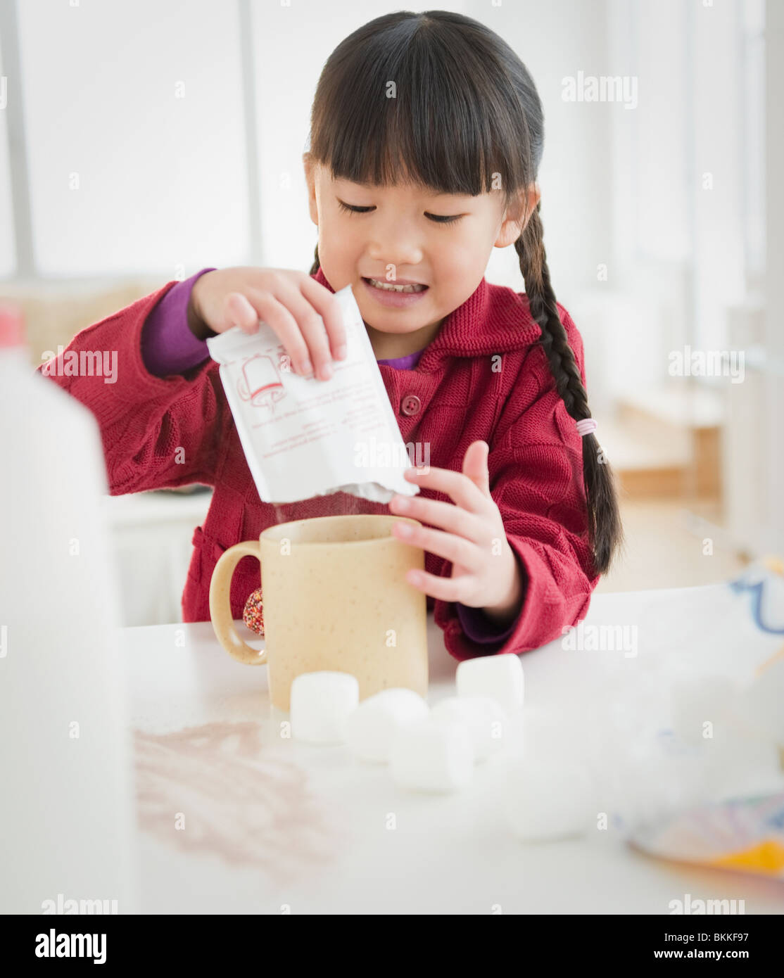 Chinese girl making hot chocolate Stock Photo - Alamy