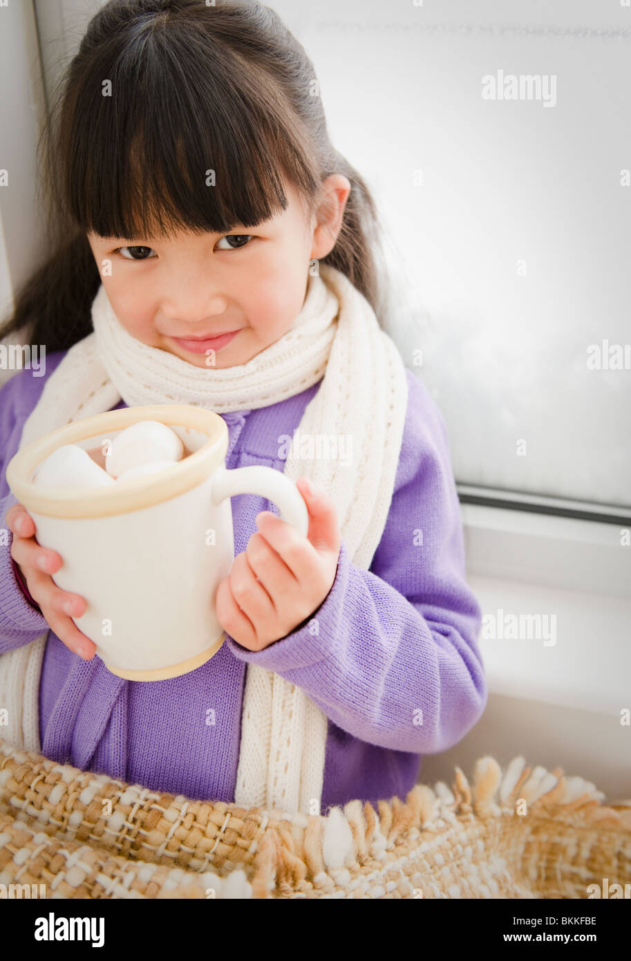 Chinese girl drinking hot chocolate Stock Photo - Alamy