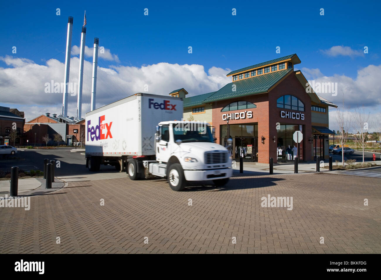 A federal express fedex delivery truck rolls out of a large shopping center in Bend, Oregon Stock Photo