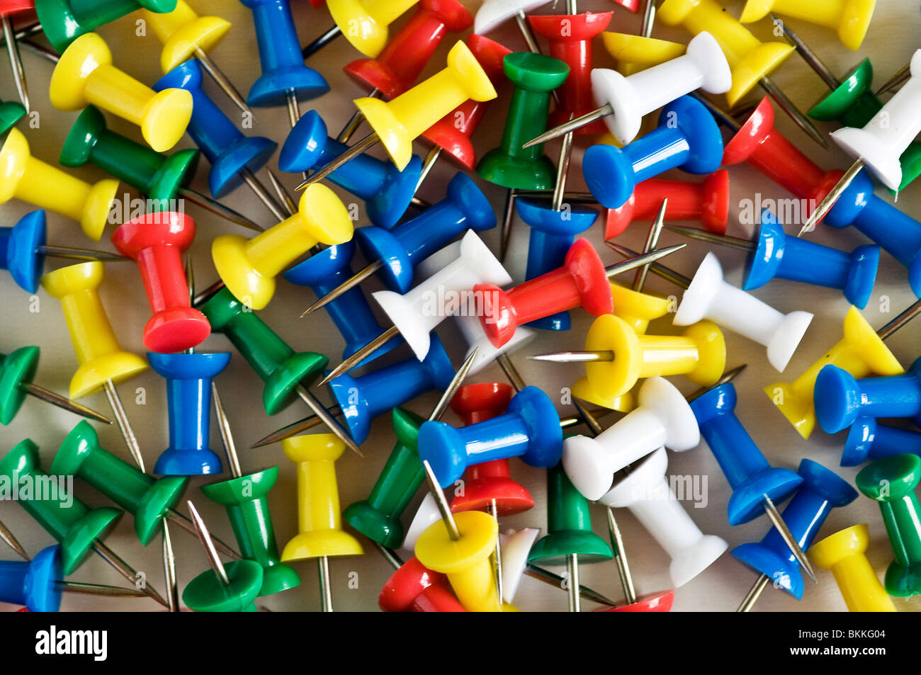 Collection of multi-coloured push pins. Stock Photo