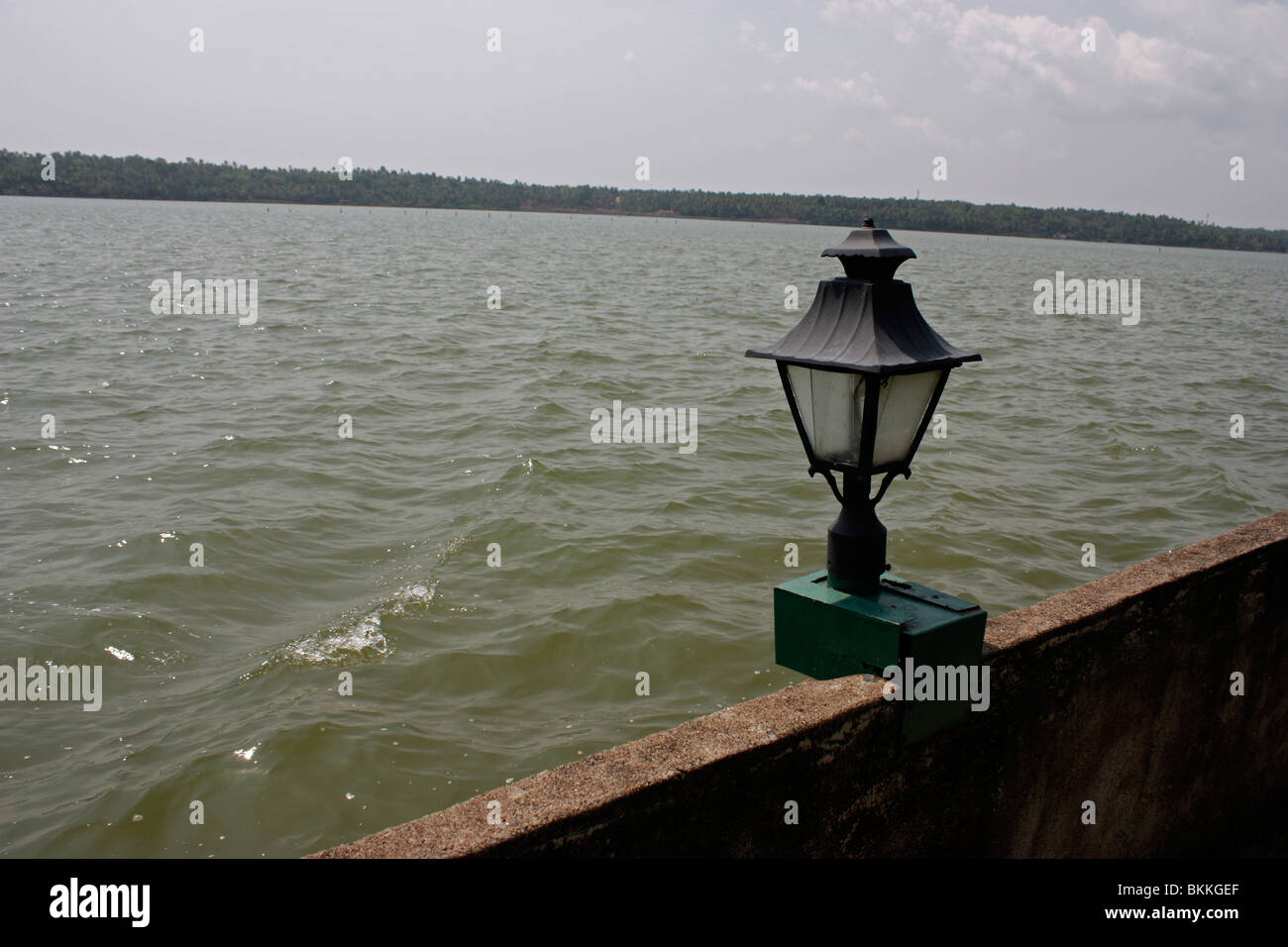 view of a lake resort over a lamp in the evening sun Stock Photo