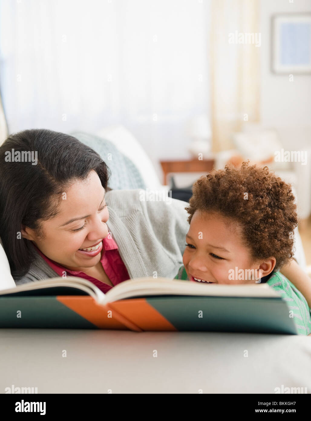 Mixed race mother reading book to son Stock Photo