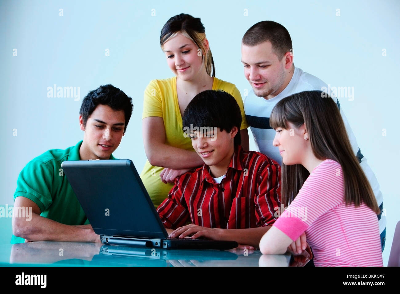 A Group Of Teenagers Looking At A Laptop Computer Stock Photo - Alamy