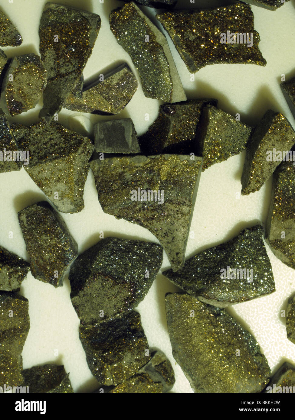 Semi precious raw chalcopyrite stones (a copper iron sulfide mineral ) Chemical composition CuFeS2. Stock Photo