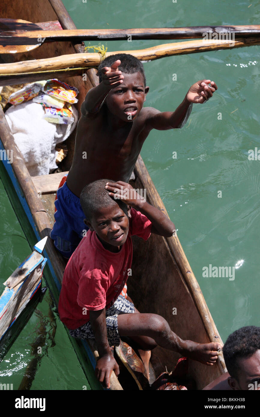 starving african street kids asking for food in wooden boats,Africa Stock Photo