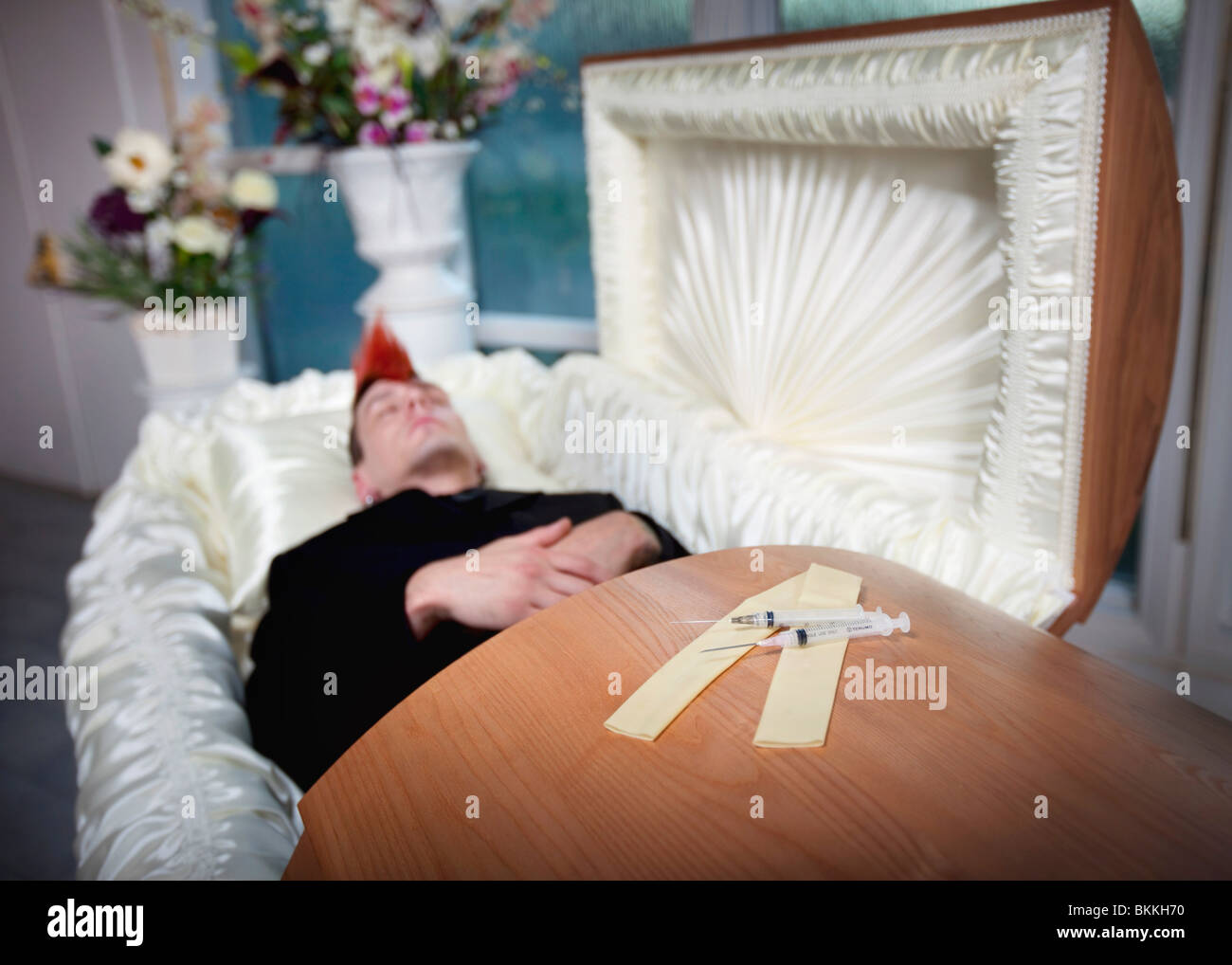 The Coffin Of A Young Man With Syringes On Top Of It Stock Photo