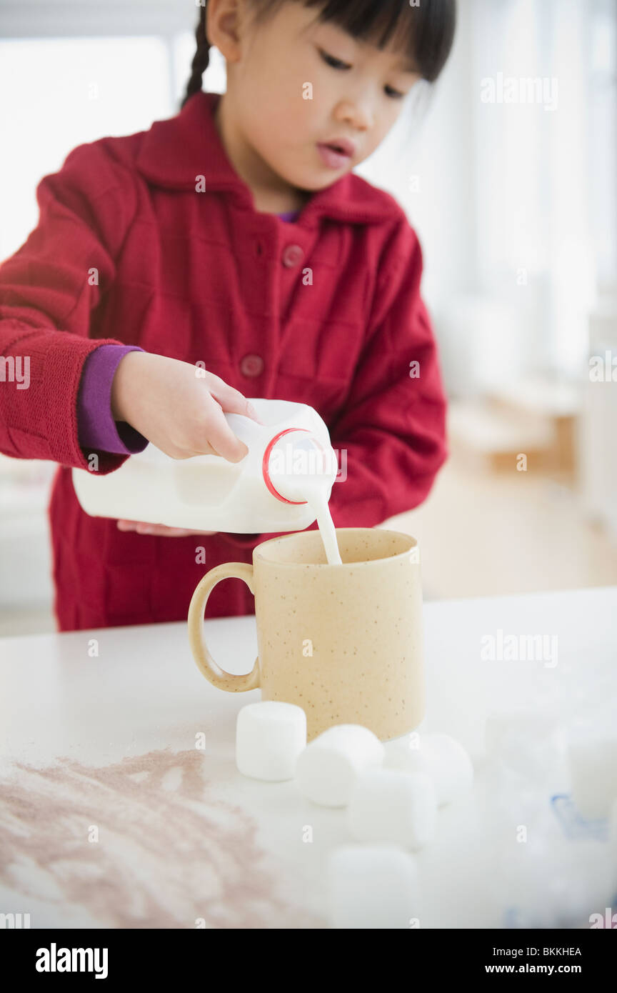 Chinese girl making hot chocolate Stock Photo - Alamy