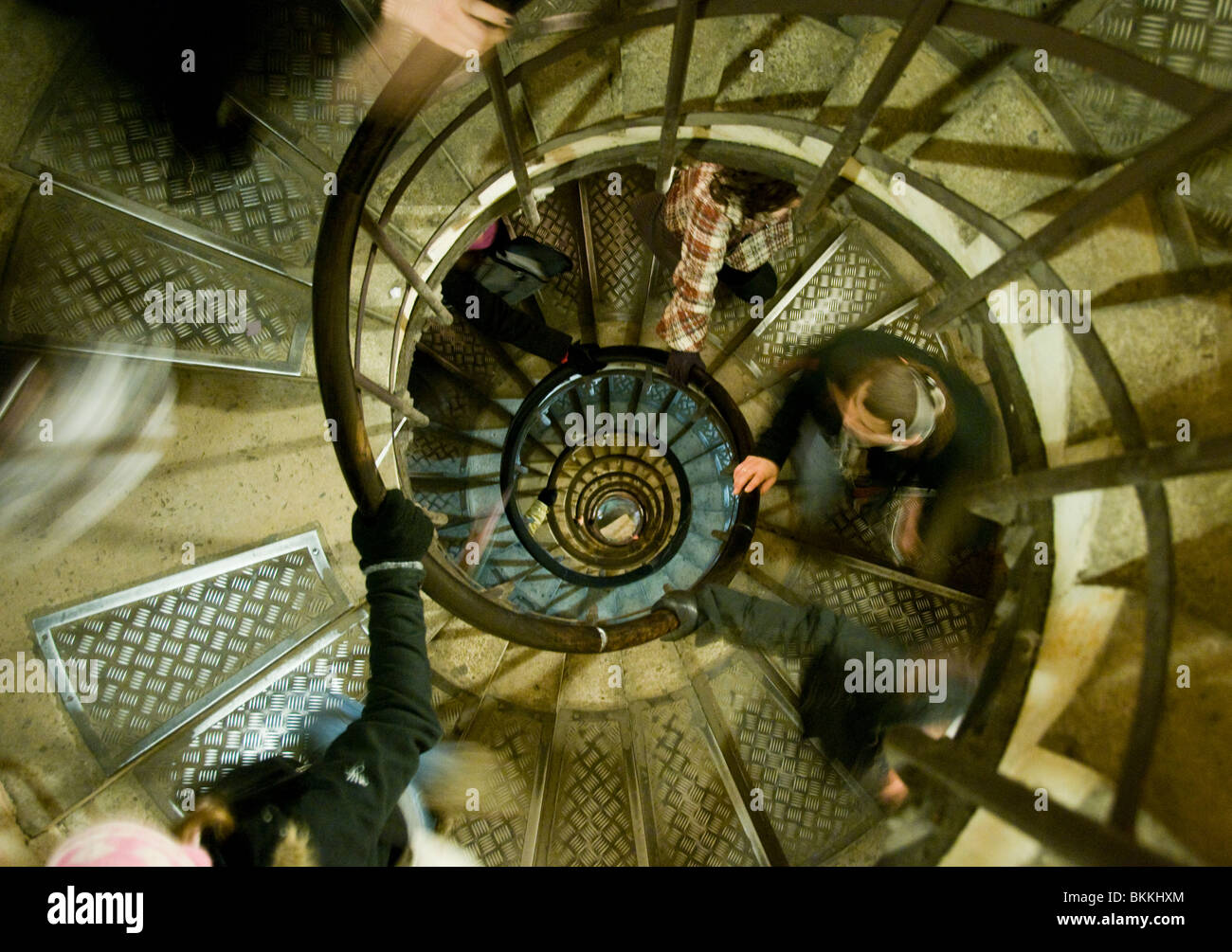 People climbing the 294 steps up the spiral staircase inside the Arc de Triomphe in Paris France Stock Photo