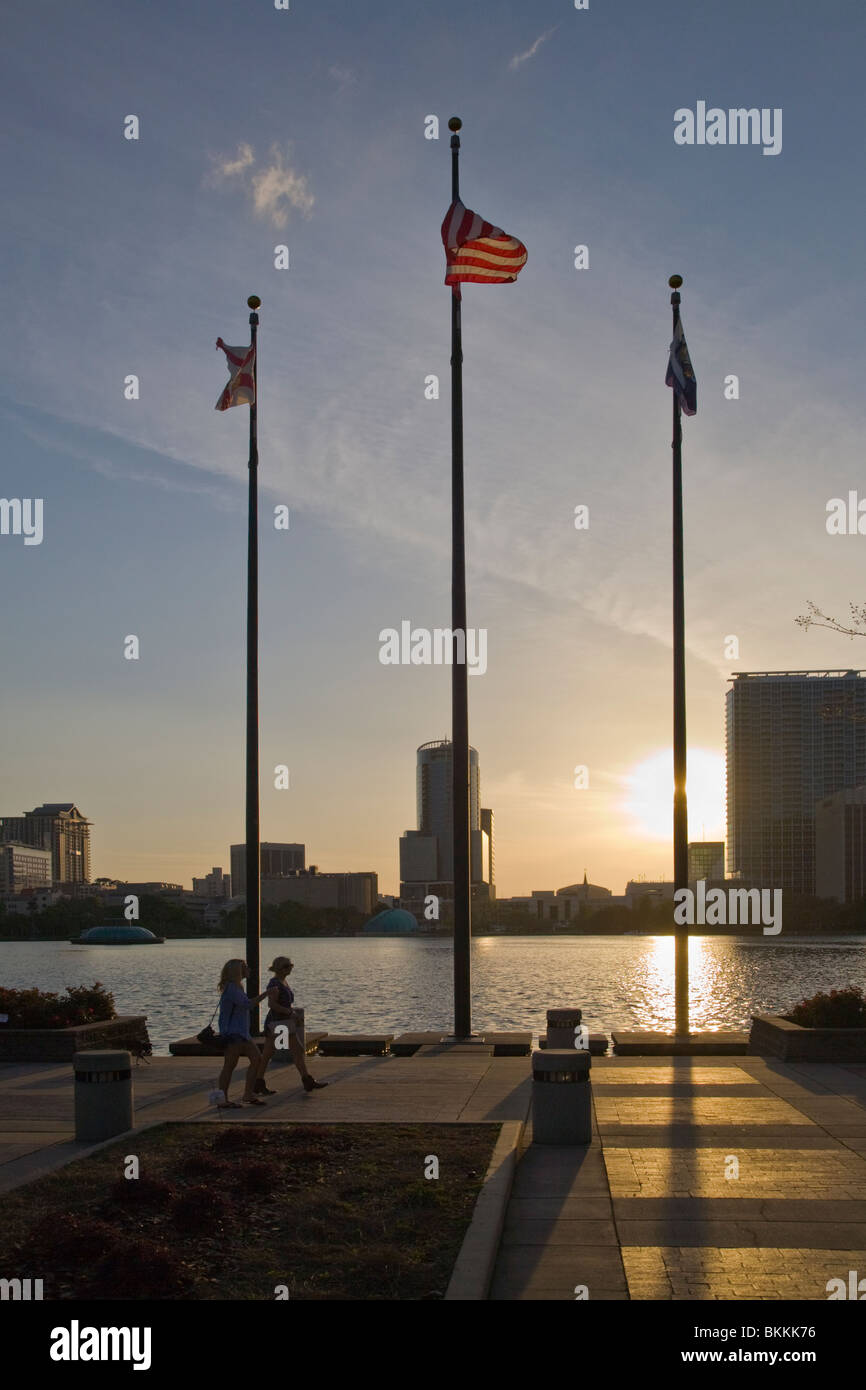 Flag poles and flags at sunset in park around Lake Eola in downtown Orlando Florida Stock Photo
