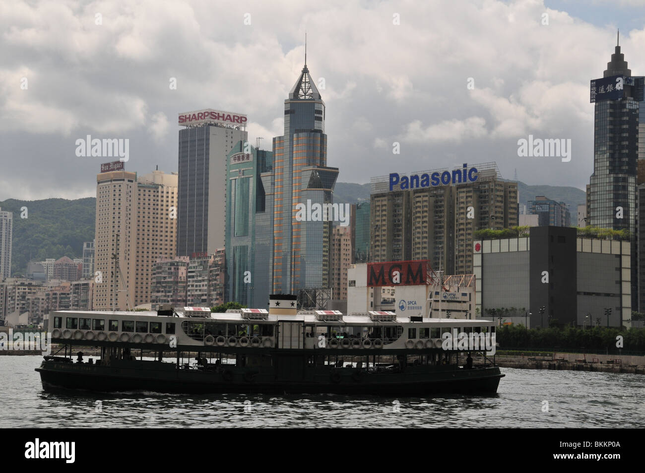 Profile of Star Ferry approaching the Wan Chai Ferry Terminal and harbourside skyscrapers, Victorai Harbour, Hong Kong, China Stock Photo