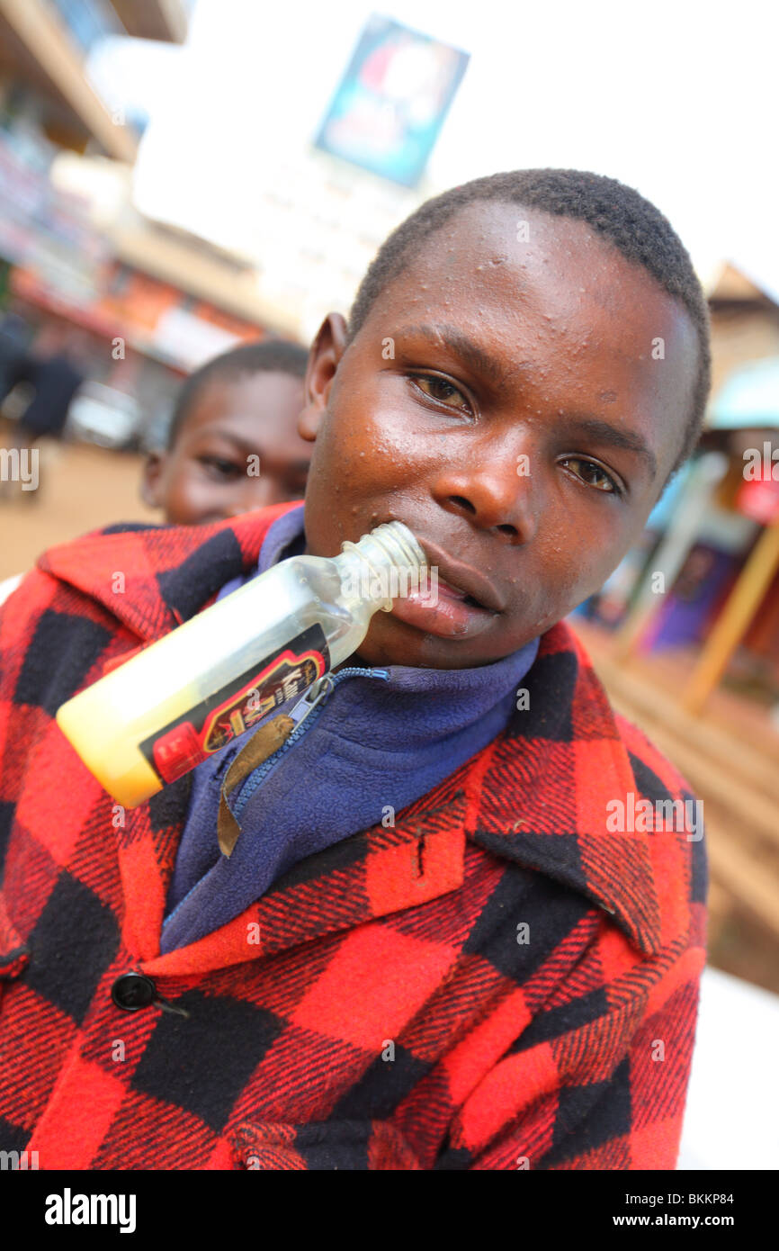 Kenya, East, Africa, village of Nyeri, glue sniffer boy child, sniffing blue, drug Stock Photo