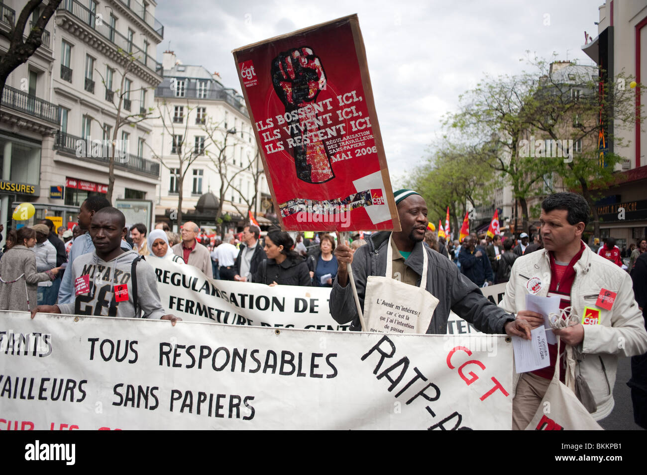 Groups of french crowd diverse People, Sans Papiers, Demonstrating in May 1, May Day Demonstration, Paris, France, Holding Protest signs, CGT, undocumented people, illegal migrants, immigration protests Stock Photo