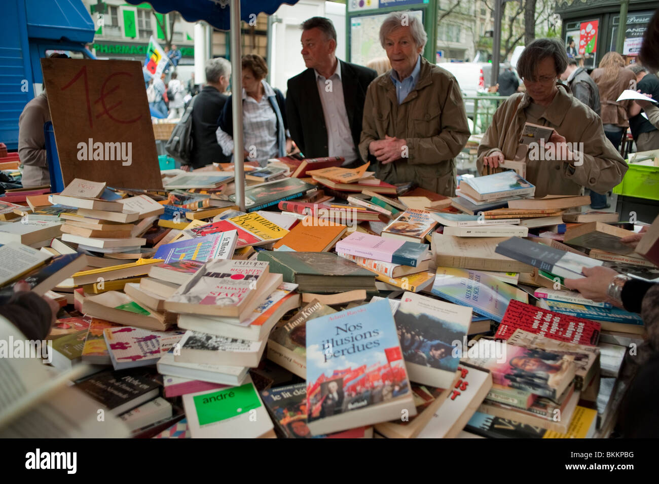 Groups of French People, Shopping at Sidewalk Garage Sale, VIntage Books, Paris, France, retirement pensioners fun, used books france, literature Stock Photo