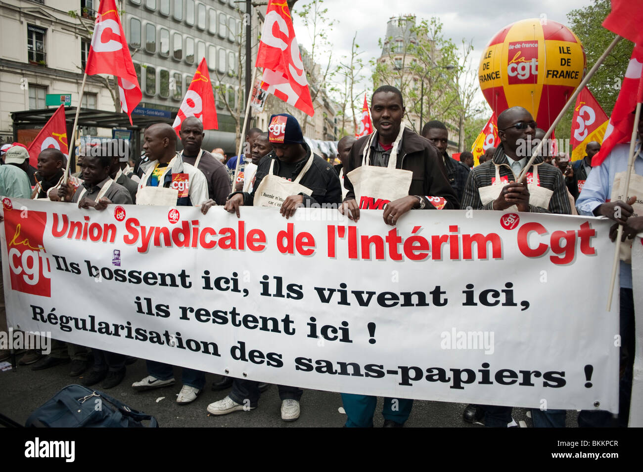 Demonstration Crowds, France's illegal aliens Sans Papiers Migrants, and trade unions protest , Paris, France; Marching with Banners, Flags, labour workers rights protests, peaceful protest sign, illegal migrants Stock Photo