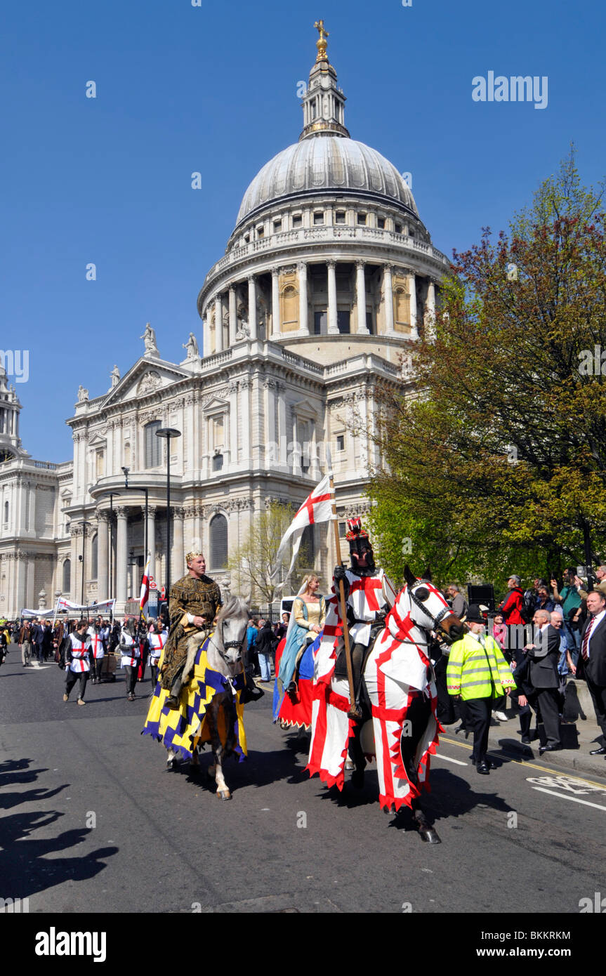 St Georges Day parade lead by horse riders & policeman passing spectators on a blue sky spring sunny day outside St Pauls Cathedral City of London UK Stock Photo
