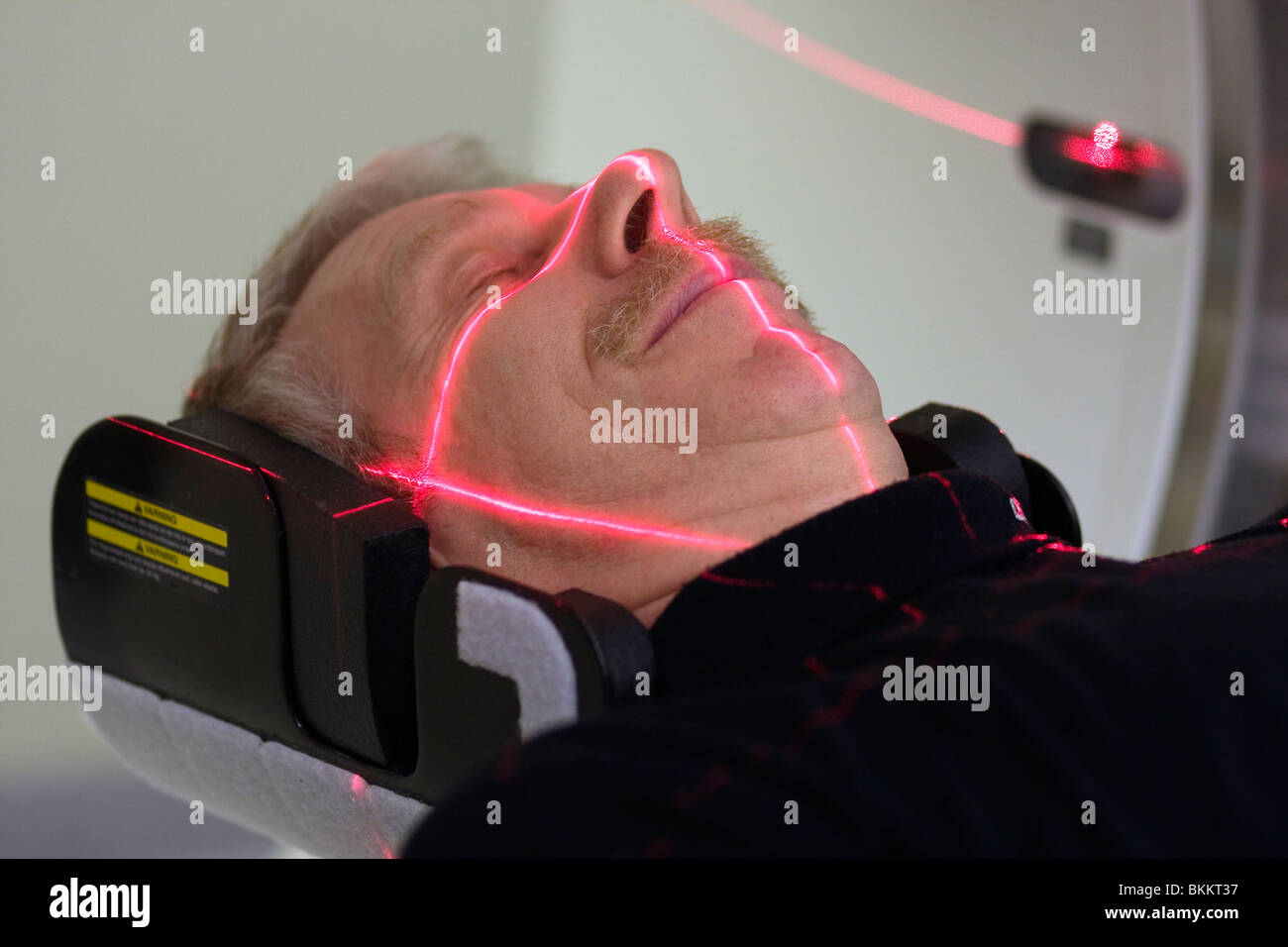 Man being adjusted to the right position before doing a CT (Computer Tomography) scan of the head. Stock Photo