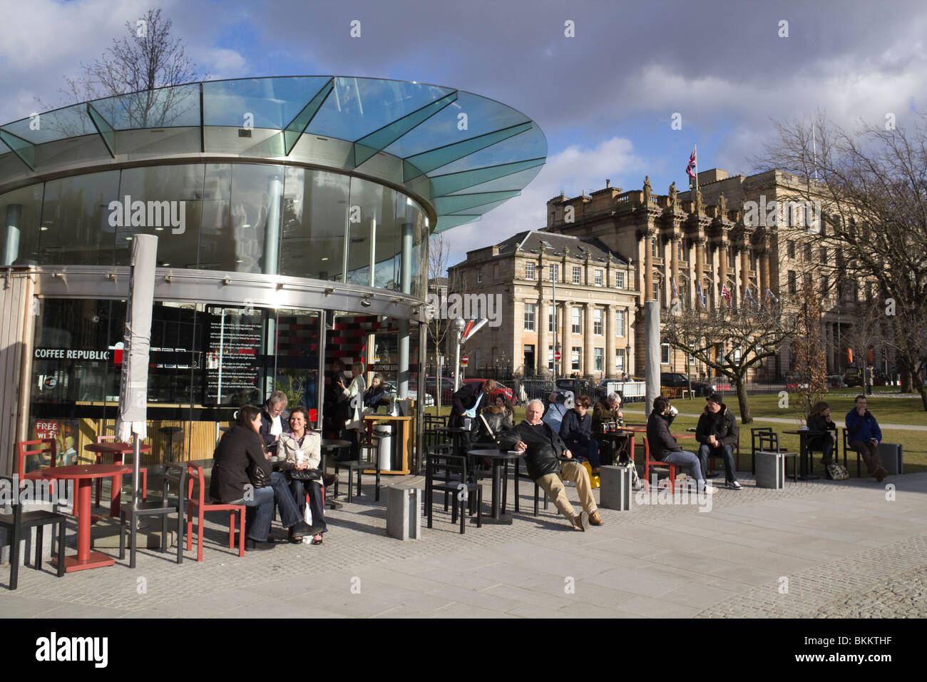 St Andrew Square Edinburgh with Coffee Republic outdoor café, customers in warm clothing sitting outdoors in March sunshine Stock Photo