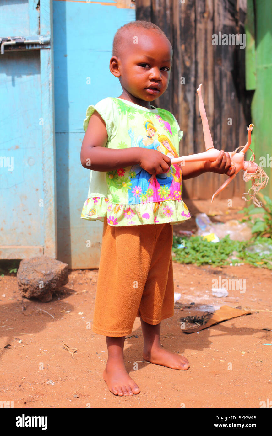 Kenya, Africa, along the road C102, portrait girl child with barbie doll Stock Photo