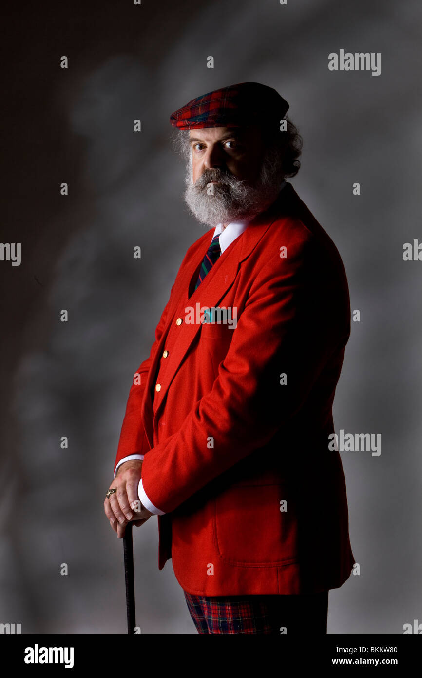 Man in a red jacket with a walking cane Stock Photo