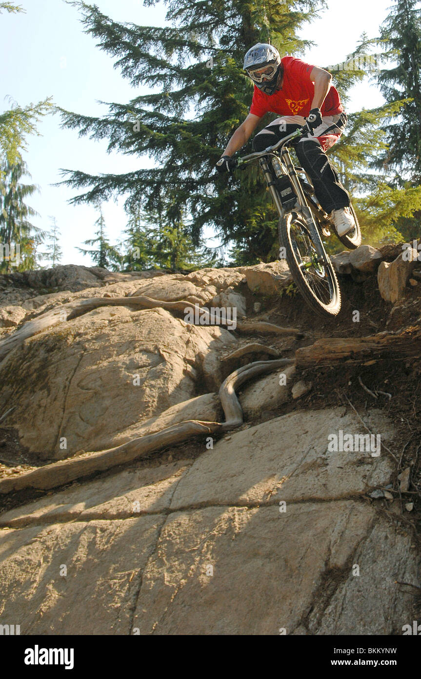 A downhill mountain biker rides a rocky descent in Whistler Mountain