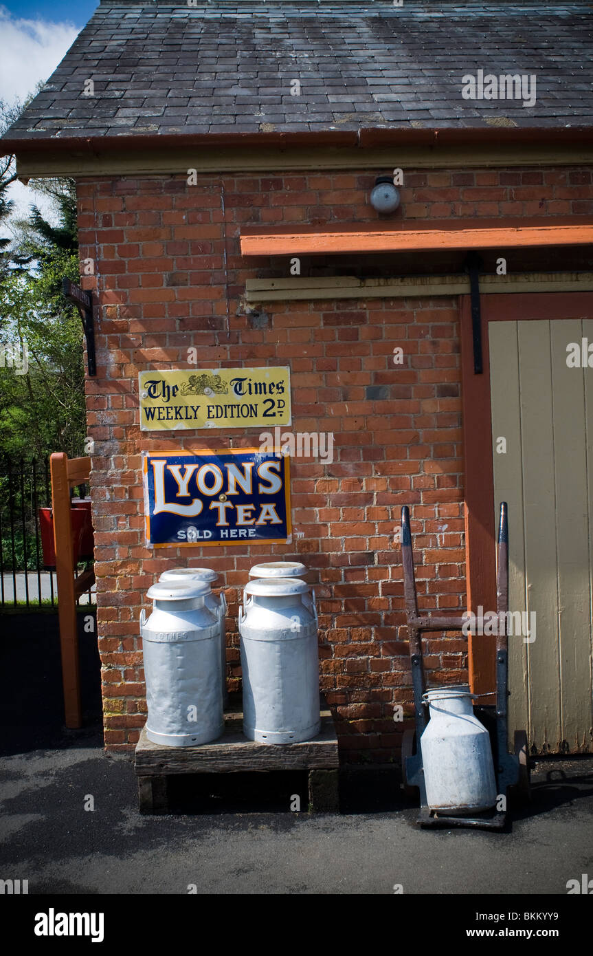 Railway equipment at Staverton railway station,milk churns,lyons tea,,signs and signifiers,semiology,bygones,pictorial enamel s Stock Photo