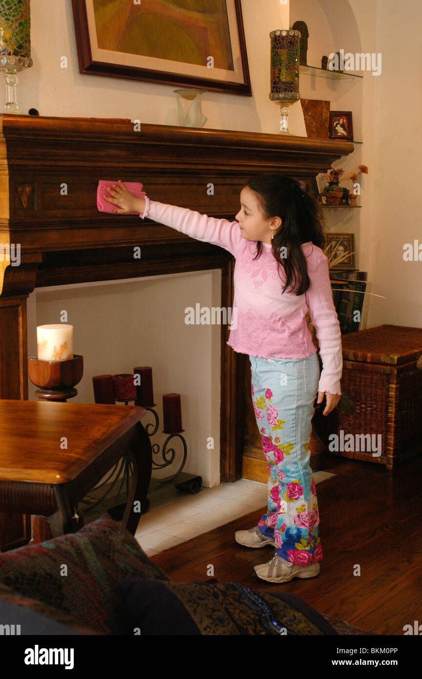 8 year old Hispanic girl cleaning house. Stock Photo