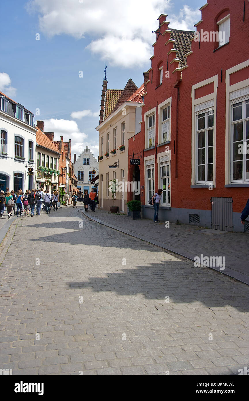 People walk down a street in historic Bruges, Belgium Stock Photo